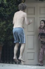 EMILIA CLARKE in Pyjamas with Her Dog Outside Her House in London 04/23/2020