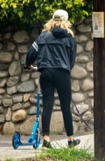 MALIN AKERMAN Rides a Scooter with Her Dog in Los Angeles 04/07/2020