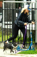 MALIN AKERMAN Rides a Scooter with Her Dog in Los Angeles 04/07/2020