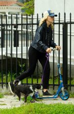 MALIN AKERMAN Rides a Scooter with Her Dog in Los Angeles 04/07/2020