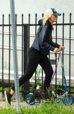 MALIN AKERMAN Rides a Scooter with Her Dog in Los Angeles 04/07/2020