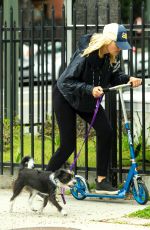 MALIN AKERMAN Rides a Scooter with Her Dog in Los Angeles 04/07/2020