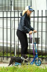 MALIN AKERMAN Rides a Scooter with Her Dog in Los Angeles 04/07/2020