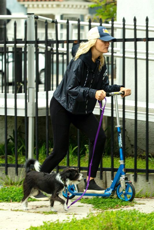 MALIN AKERMAN Rides a Scooter with Her Dog in Los Angeles 04/07/2020