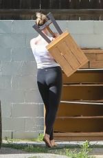 IRELAND BALDWIN Offloading a Table and Chairs from Her Truck in Los Angeles 05/22/2020