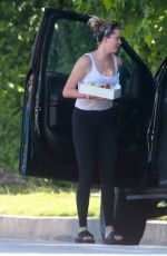 IRELAND BALDWIN Offloading a Table and Chairs from Her Truck in Los Angeles 05/22/2020