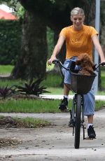 DEVON WINDSOR Out Riding a Bike with Her Dog in Miami 06/06/2020