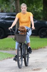 DEVON WINDSOR Out Riding a Bike with Her Dog in Miami 06/06/2020