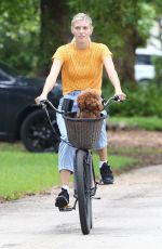 DEVON WINDSOR Out Riding a Bike with Her Dog in Miami 06/06/2020