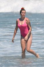 IRELAND BALDWIN in a Pink Swimsuit on the Beach in Malibu 07/20/2020