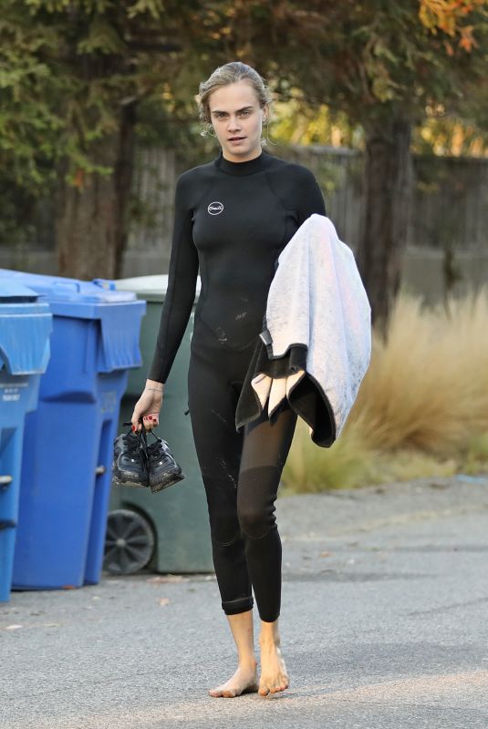 CARA DELEVINGNE in Wetsuit Out Surfing in Malibu 08/18/2020