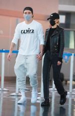 NICOLA PELTZ and Brooklyn Beckham at JFK AIrport in New York 11/07/2020