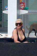 CHRISTINA AGUILRA in Swimsuit at a Pool in Miami 02/12/2021