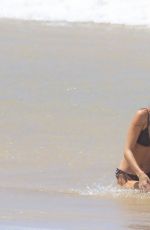 GABRIELLA BROOKS in Bikini and Liam Hemsworth at a Beach in Byron Bay 02/24/2021