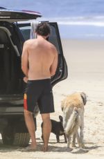 GABRIELLA BROOKS in Bikini and Liam Hemsworth at a Beach in Byron Bay 02/24/2021