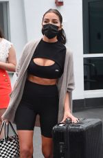 OLIVIA CULPO in Tights Rolls Her Luggage Out in Miami 02/06/2021