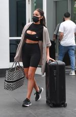 OLIVIA CULPO in Tights Rolls Her Luggage Out in Miami 02/06/2021