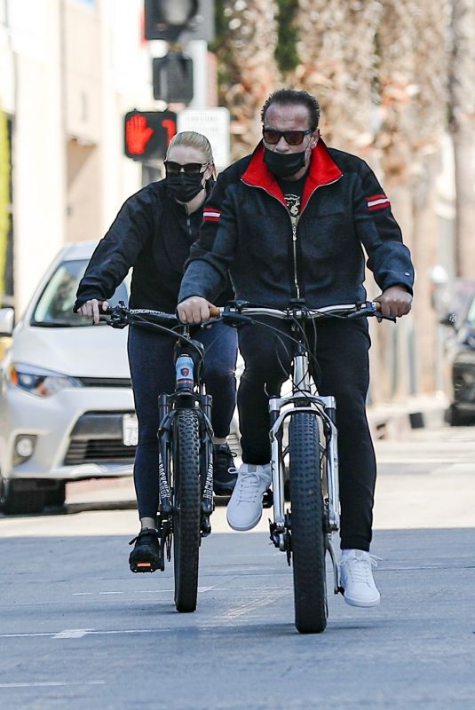 HEATHER MILLIGAN and Arnold Schwarzenegger Out Riding Bikes in Santa Monica 03/13/2021