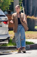 ASHLEE SIMPSON Picks up a For Sale Sign from Her Old House in Sherman Oaks 05/25/2021