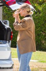 ASHLEE SIMPSON Picks up a For Sale Sign from Her Old House in Sherman Oaks 05/25/2021