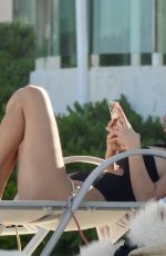 FRANCESCA FARAGO in a Black Swimsuit at a Beach 05/18/2021