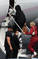 KYLIE JENNER and Travis Scott Boarding on a Jet in Miami 05/03/2021