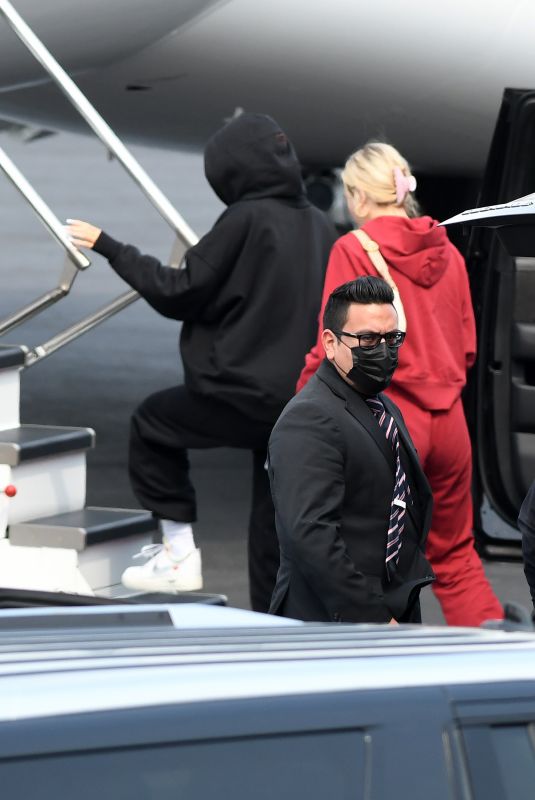 KYLIE JENNER and Travis Scott Boarding on a Jet in Miami 05/03/2021