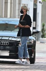 CHARLIZE THERON in Ripped Denim Out Shopping in Beverly Hills 07/16/2021