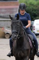 KATIE PRICE Riding a Horse at Her Stables in Essex 07/22/2021
