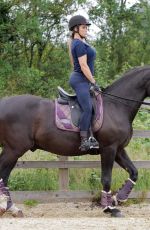 KATIE PRICE Riding a Horse at Her Stables in Essex 07/22/2021