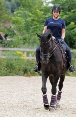KATIE PRICE Riding a Horse at Her Stables in Essex 07/22/2021