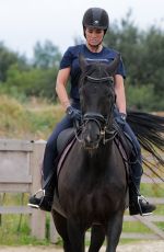 KATIE PRICE Riding a Horse at Her Stables in Essex 07/22/2021