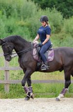 KATIE PRICE Riding a Horse at Her Stables in Essex 07/22/2021