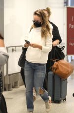 OLIVIA WILDE in Ripped Denim at LAX Airport in Los Angeles 07/19/2021