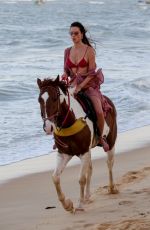 ALESSANDRA AMBROSIO in a Red Bikini Riding a Horse at a Beach in Trancoso 08/05/2021