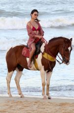 ALESSANDRA AMBROSIO in a Red Bikini Riding a Horse at a Beach in Trancoso 08/05/2021