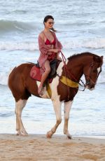 ALESSANDRA AMBROSIO in a Red Bikini Riding a Horse at a Beach in Trancoso 08/05/2021