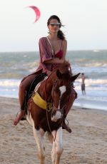 ALESSANDRA AMBROSIO in a Red Bikini Riding a Horse at a Beach in Trancoso 08/05/2021