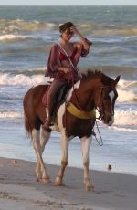 ALESSANDRA AMBROSIO in a Red Bikini Riding a Horse at a Beach in Trancoso 08/05/2021