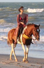 ALESSANDRA AMBROSIO in a Red Bikini Riding a Horse at a Beach in Trancoso 08/05/2021