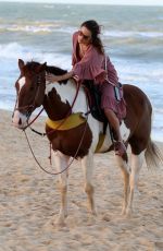 ALESSANDRA AMBROSIO in a Red Bikini Riding a Horse at a Beach in Trancoso 08/05/2021