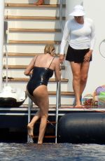 CHARLIZE THERON in a Black Swimsuit at a Yacht in Greece 08/08/2021