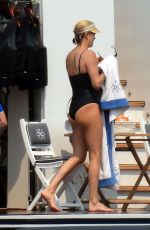 CHARLIZE THERON in a Black Swimsuit at a Yacht in Greece 08/08/2021