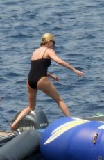 CHARLIZE THERON in a Black Swimsuit at a Yacht in Greece 08/08/2021