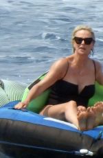 CHARLIZE THERON in a Black Swimsuit at a Yacht in Greece 08/08/2021