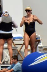 CHARLIZE THERON in a Black Swimsuit at a Yacht in Greece 08/08/2021