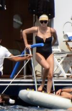 CHARLIZE THERON in a Black Swimsuit at a Yacht in Greece 08/08/2021