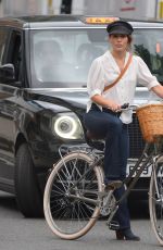 MELIA KREILING Riding a Bike on the Set of Mammals in London 08/03/2021