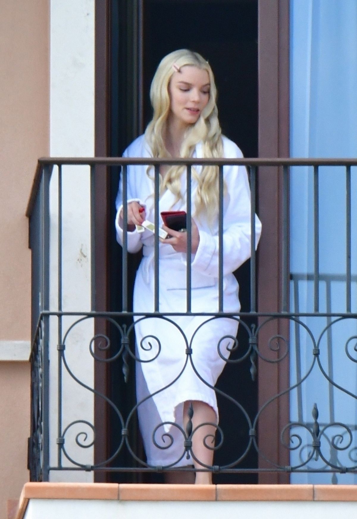 ANYA TAYLORJOY Enjoys a Cigarette on Her Hotel Balcony in