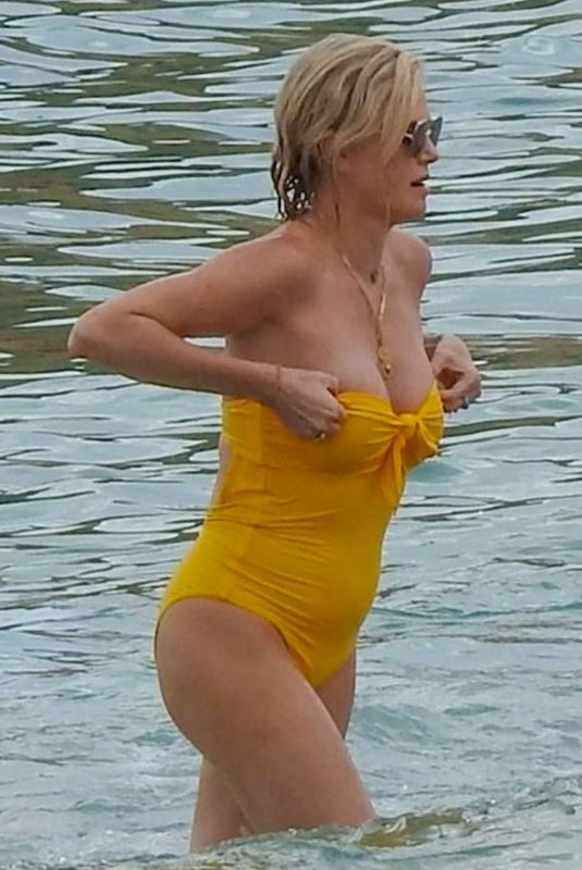 CHARLIZE THERON in a Yellow Swimsuit in Cabo San Lucas 11/26/2021